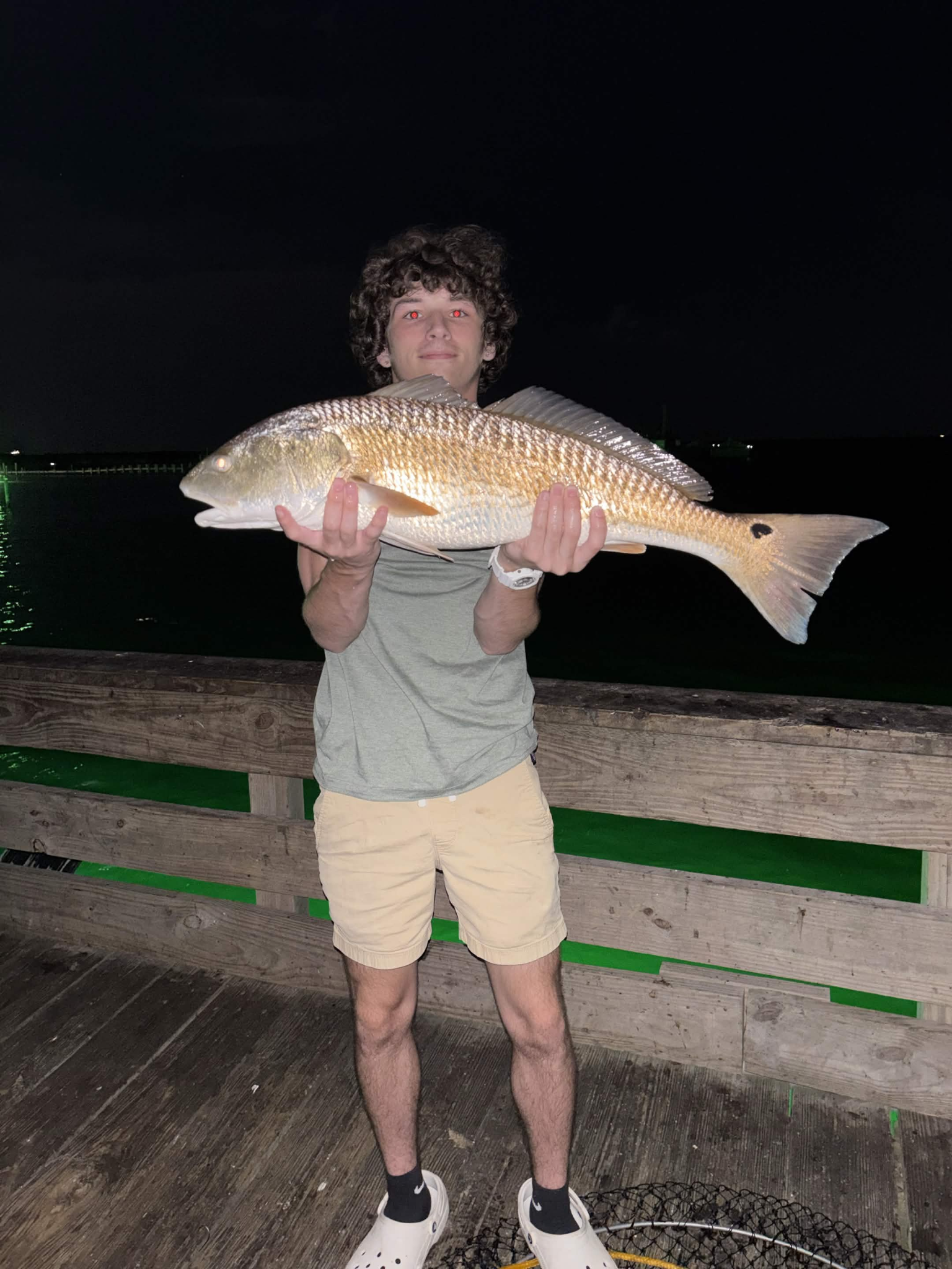 Jaden Matherne, founder of Rapid Scales Marketing, holding a fish